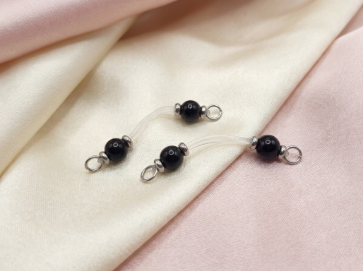 Black Obsidian Nipple Rings High-end close-up of a pair of non-piercing intimate body jewelry rings featuring genuine high-polish Black Obsidian gemstones