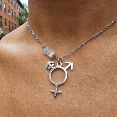 Transgender Pride Statement Necklace Close-up of a model wearing a premium stainless steel transgender pride lifestyle necklace with symmetrically integrated pink, white, and bl