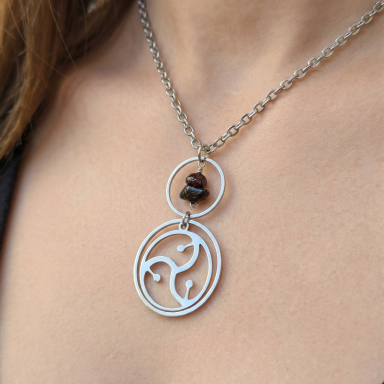 Triskelion Lifestyle Statement Necklace: Close-up of a model wearing a premium high-polish stainless steel triskelion lifestyle symbol necklace on an elegant fine-link chain.